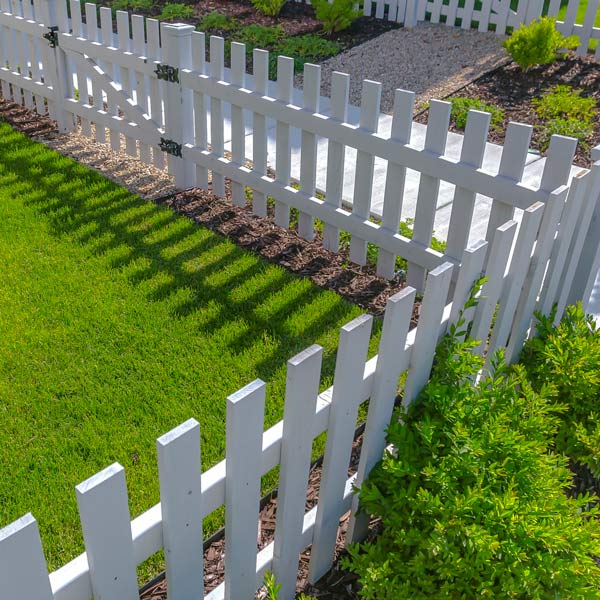 landscaping around white picket fence